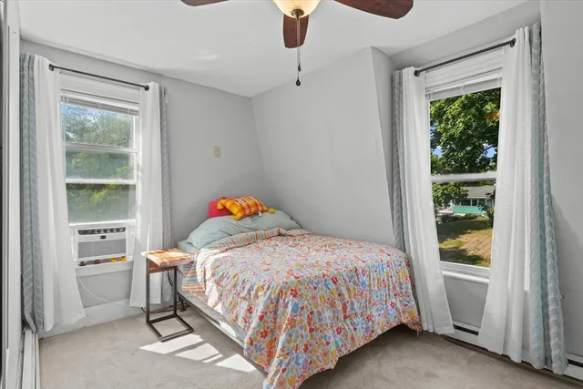 a bedroom with a bed and window