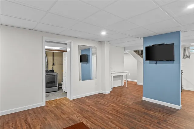 a view of a livingroom with wooden floor and a flat screen tv