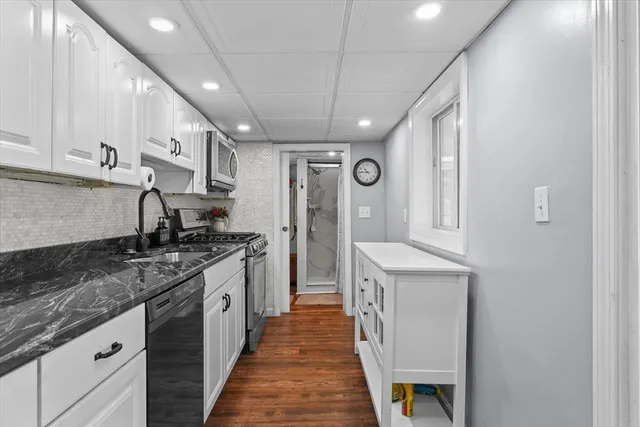 a kitchen with stainless steel appliances granite countertop a sink and cabinets