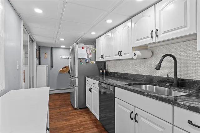 a kitchen with stainless steel appliances granite countertop a sink and cabinets