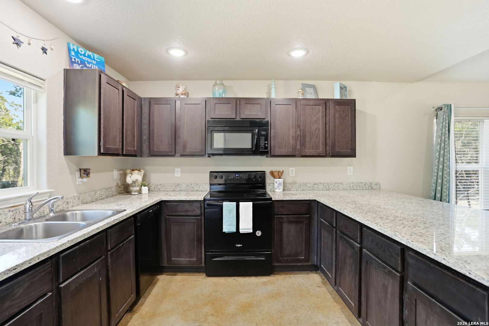 341 Ridge Road Spring Branch, TX 78070 - Photo 8 of 23 a kitchen with a sink and a stove top oven with wooden floor