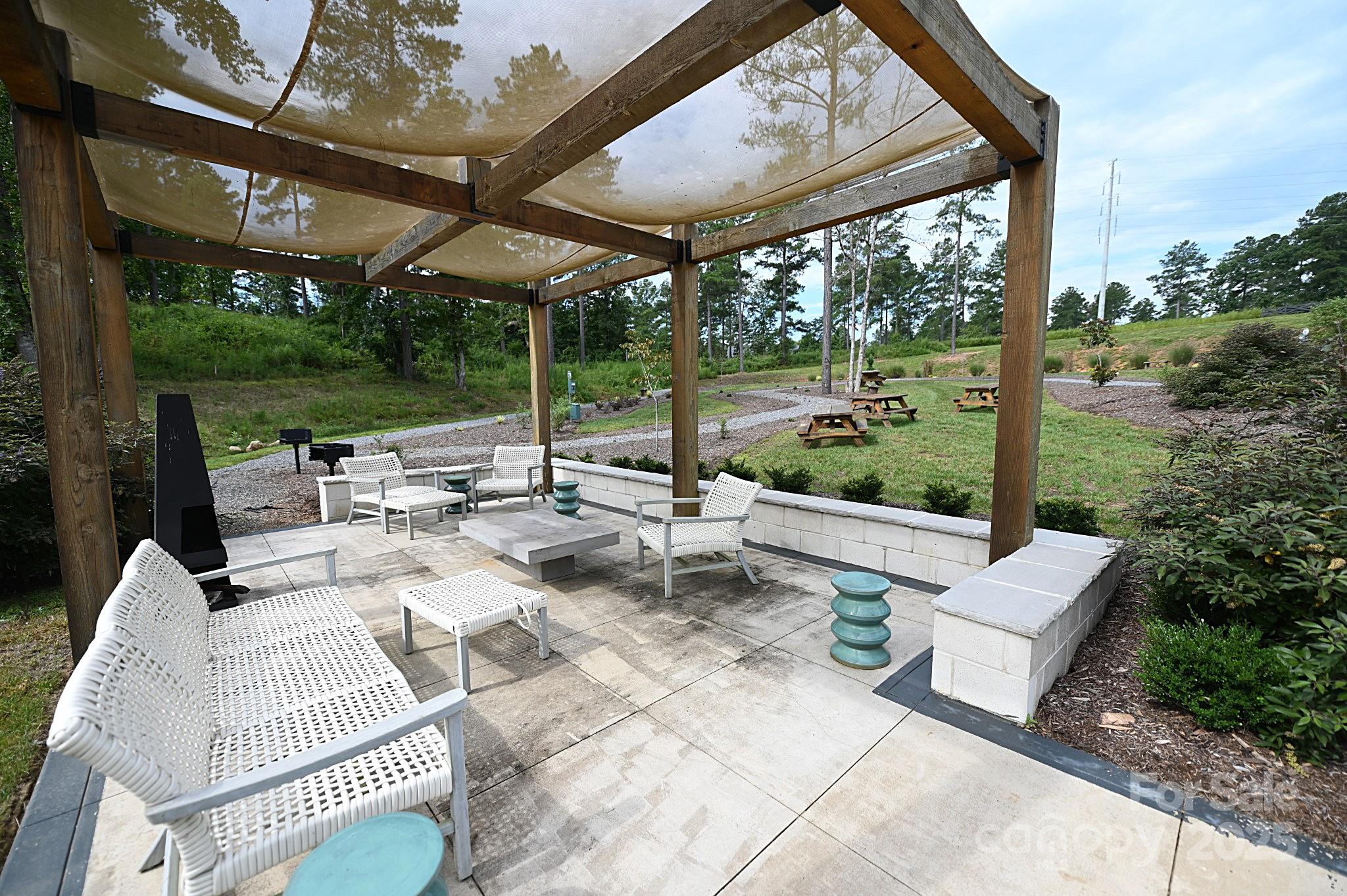 2576 Jumping Run Connelly Springs, NC 28612 - Photo 26 of 29 a view of a patio with a table chairs and a floor to ceiling window