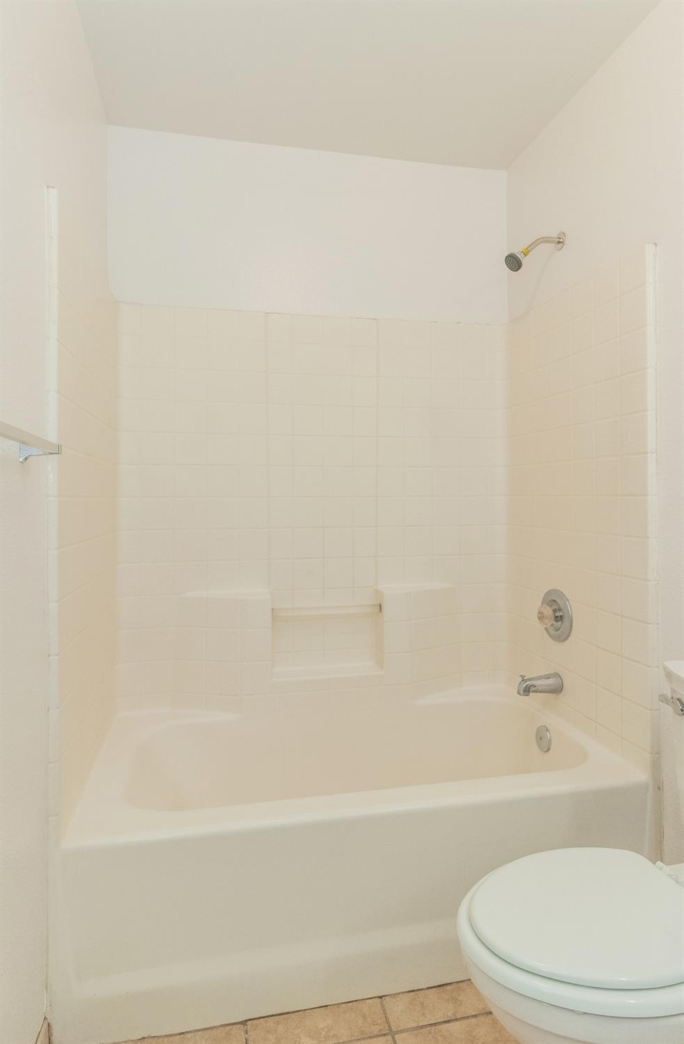 13551 7th Street Parlier, CA 93648 - Photo 11 of 17 a bathroom with a toilet and a bathtub