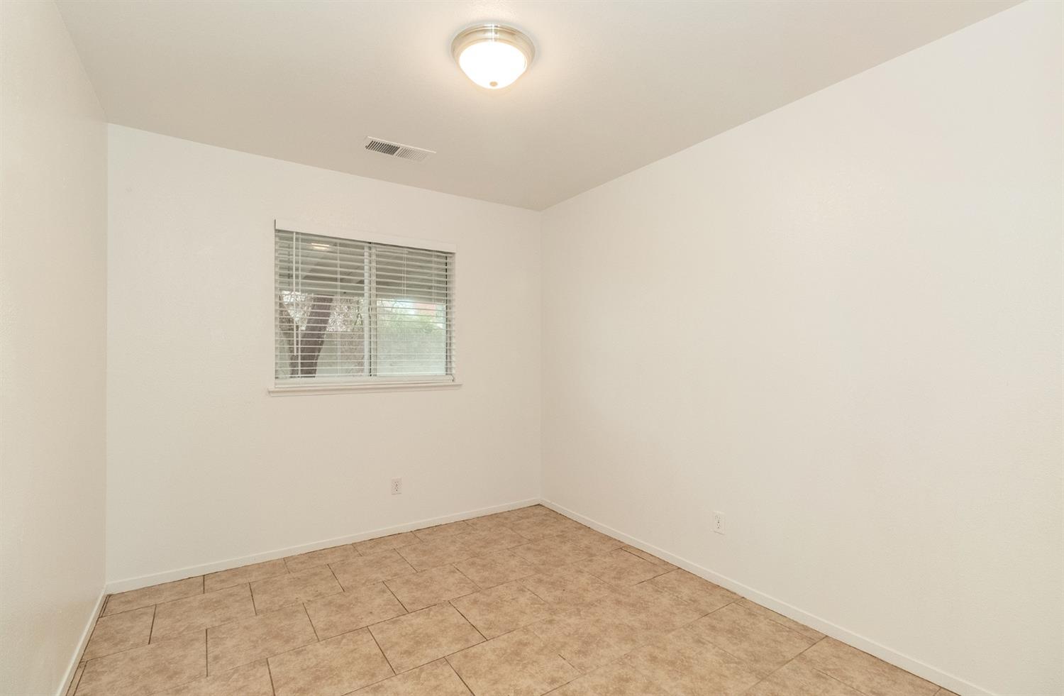13551 7th Street Parlier, CA 93648 - Photo 12 of 17 an empty room with windows