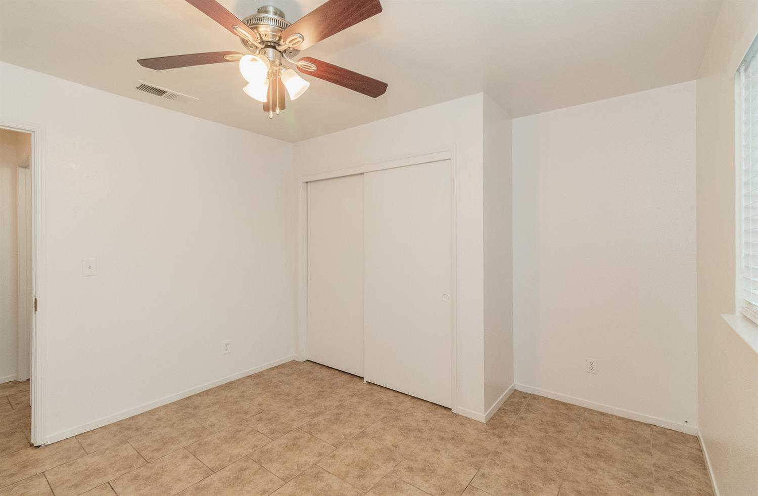 13551 7th Street Parlier, CA 93648 - Photo 15 of 17 an empty room with a fan and a fan