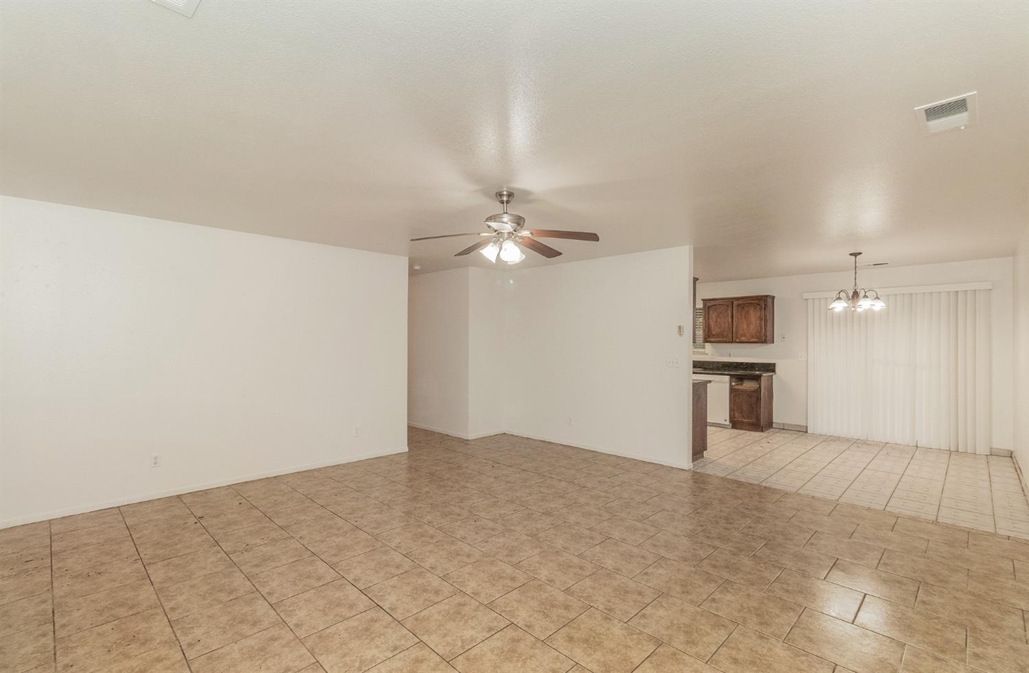 13551 7th Street Parlier, CA 93648 - Photo 3 of 17 a view of a kitchen with a sink and a refrigerator