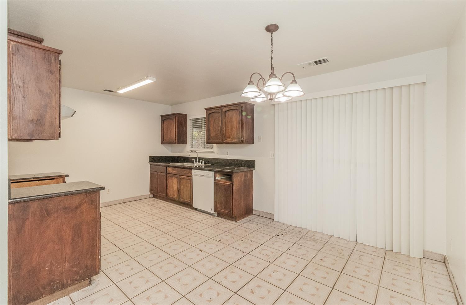 13551 7th Street Parlier, CA 93648 - Photo 4 of 17 a kitchen with stainless steel appliances a stove top oven and cabinets