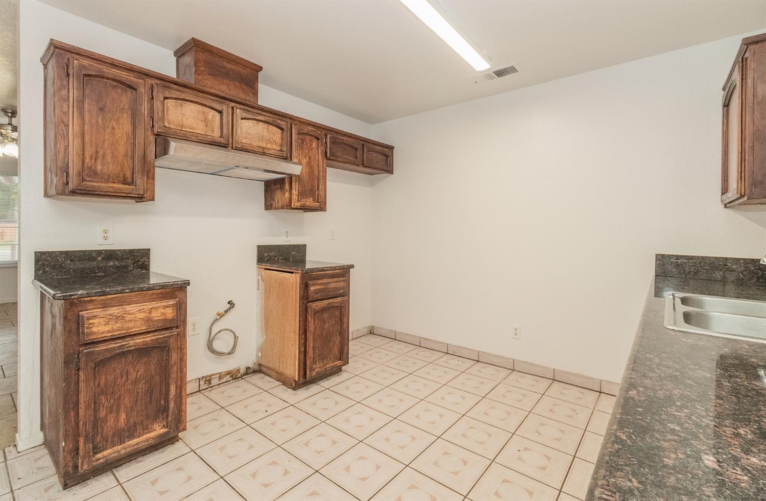 13551 7th Street Parlier, CA 93648 - Photo 6 of 17 a kitchen with stainless steel appliances a stove and a refrigerator