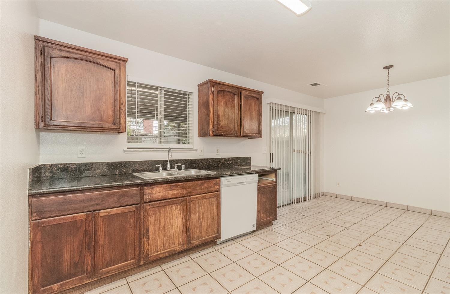 13551 7th Street Parlier, CA 93648 - Photo 7 of 17 a kitchen with granite countertop white cabinets and stainless steel appliances