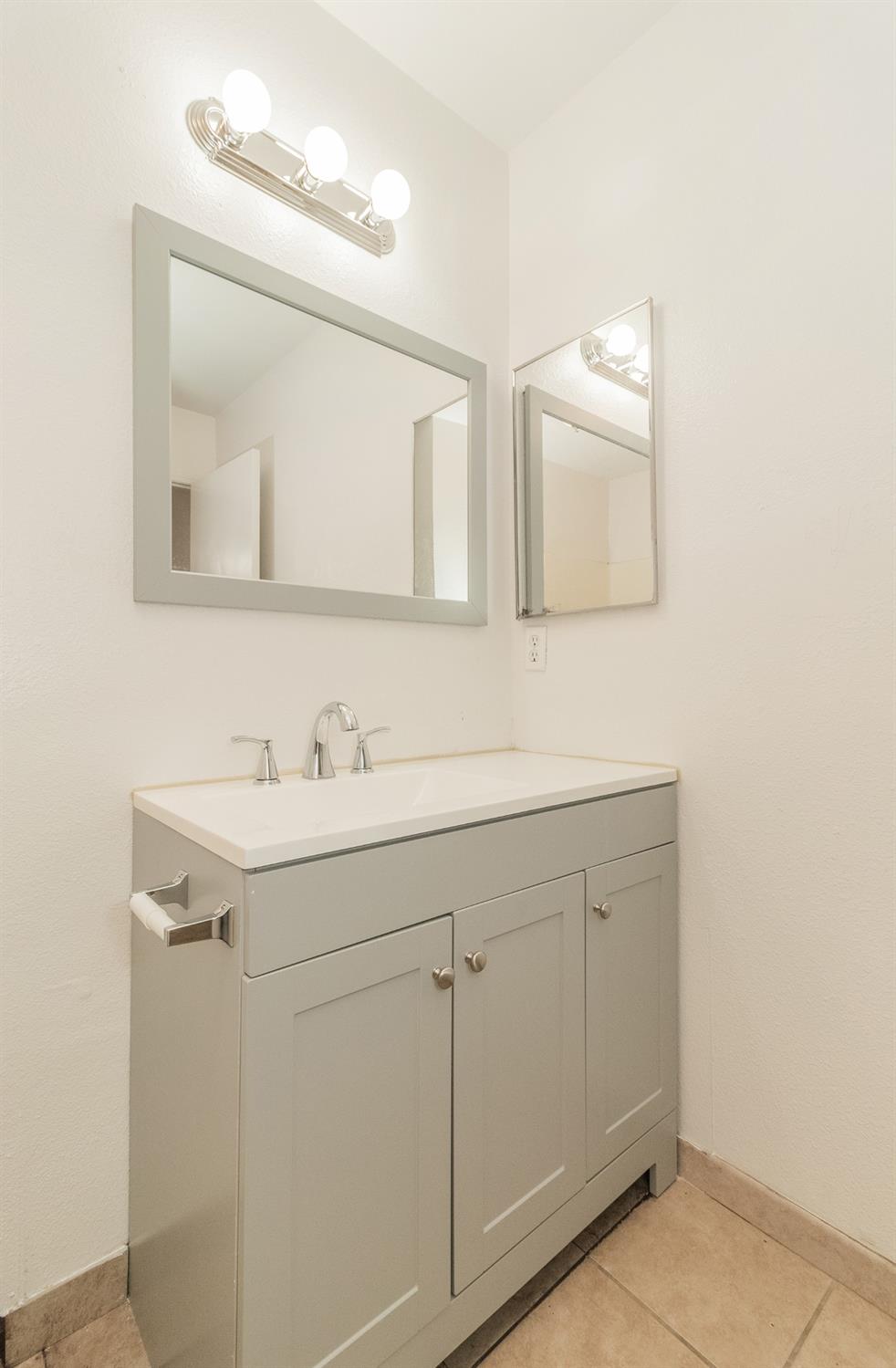 13551 7th Street Parlier, CA 93648 - Photo 10 of 17 a bathroom with a sink and a mirror