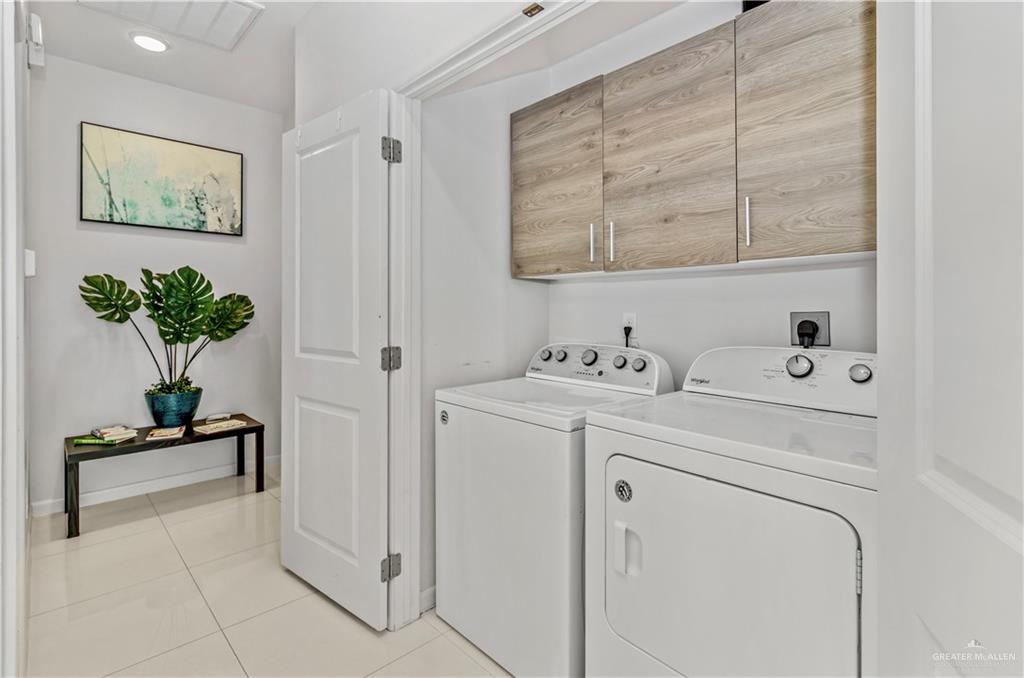 5708 Nightingale Avenue, Unit 2 Mission, TX 78573 - Photo 6 of 12 Laundry area with cabinets, independent washer and dryer, and light tile patterned flooring