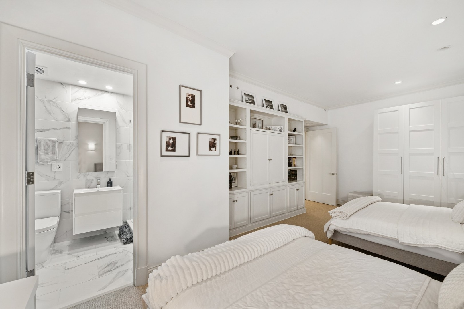 230 East Delaware Place, Unit 2W Chicago, IL 60611 - Photo 15 of 21 a bedroom with a bed and a refrigerator