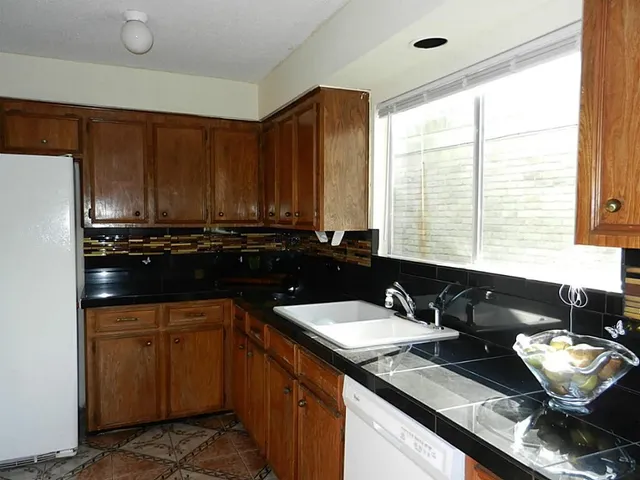 a kitchen with a sink stove and cabinets