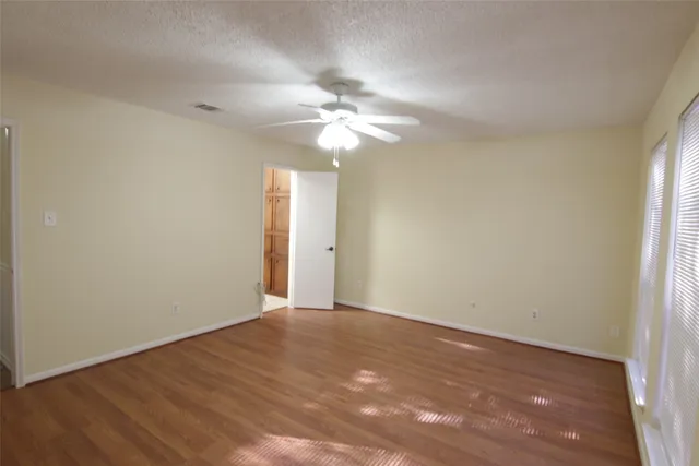 a view of an empty room with a fan
