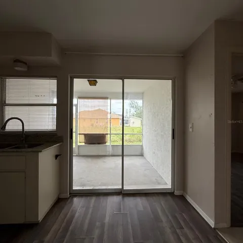 a view of hallway with wooden floor and furniture