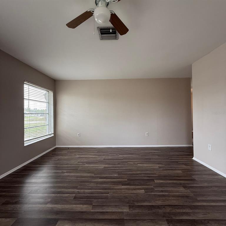 201 San Marco Avenue, Unit 1 North Port, FL 34287 - Photo 12 of 13 wooden floor in an empty room with a window