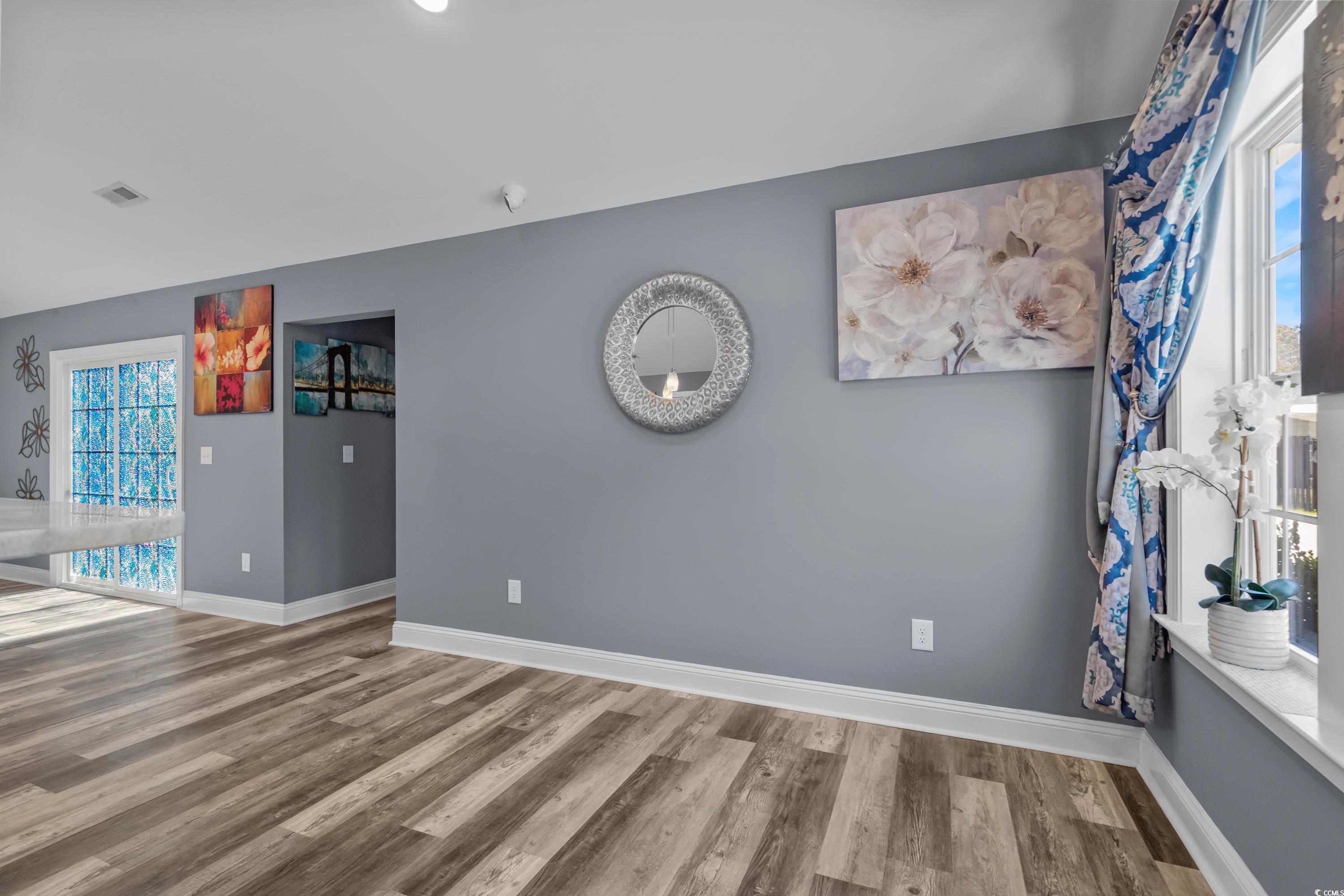 3836 Journeys End Road Murrells Inlet, SC 29576 - Photo 17 of 40 Empty room with baseboards, visible vents, and woo