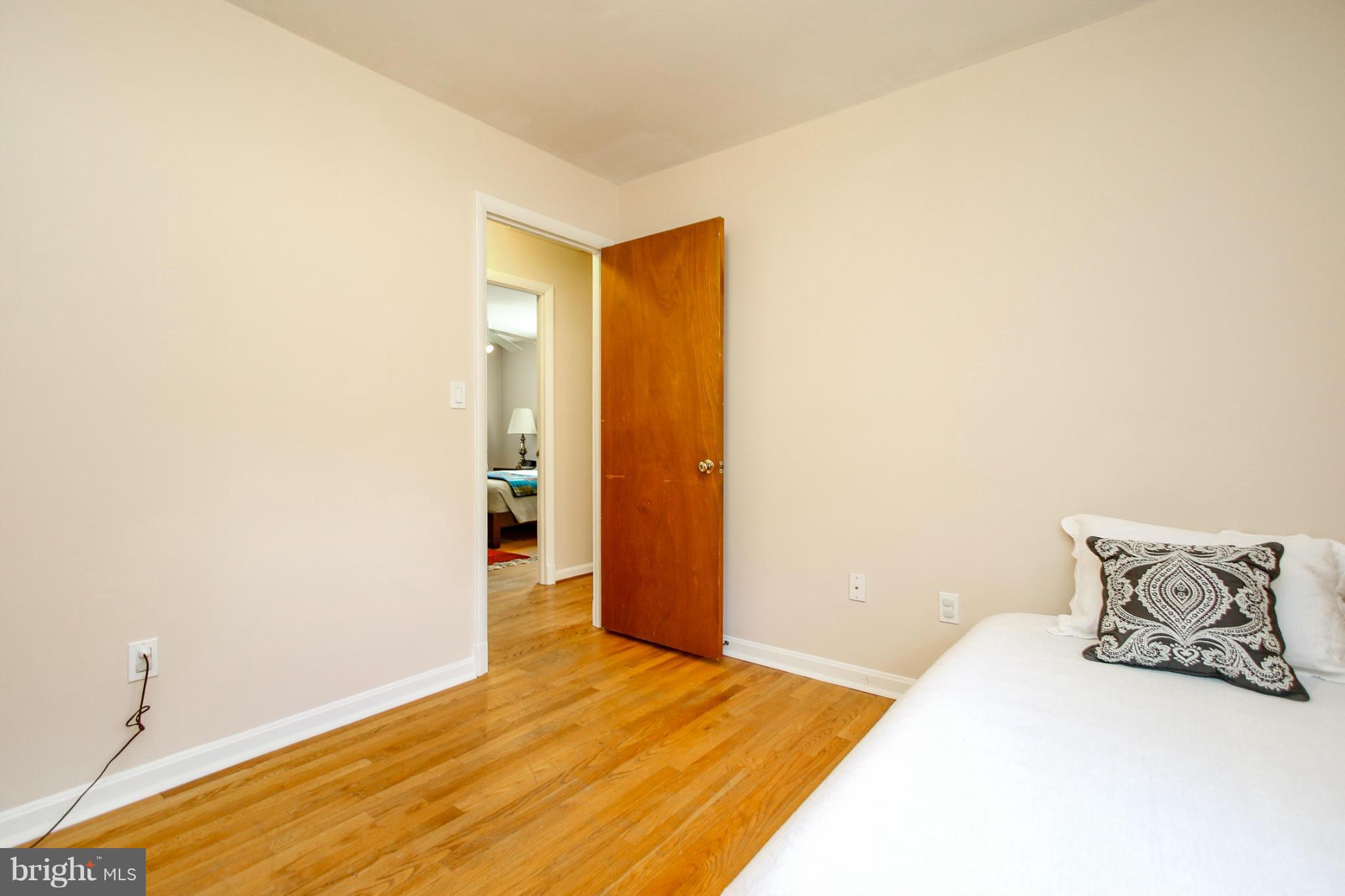 13201 Clifton Road Silver Spring, MD 20904 - Photo 15 of 30 a bedroom with a bed and wooden floor