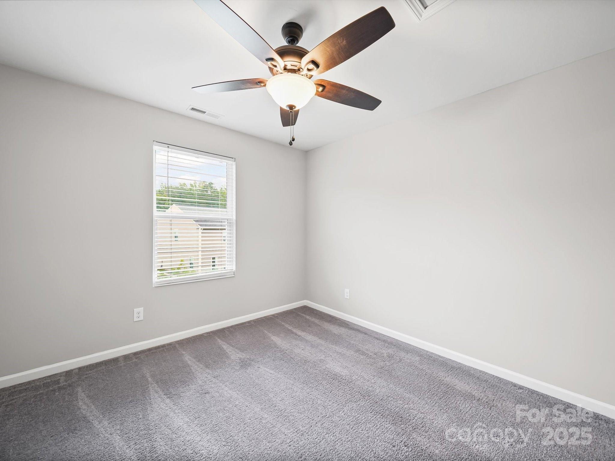 3013 Riker Street Clover, SC 29710 - Photo 25 of 39 an empty room with a window and a fan