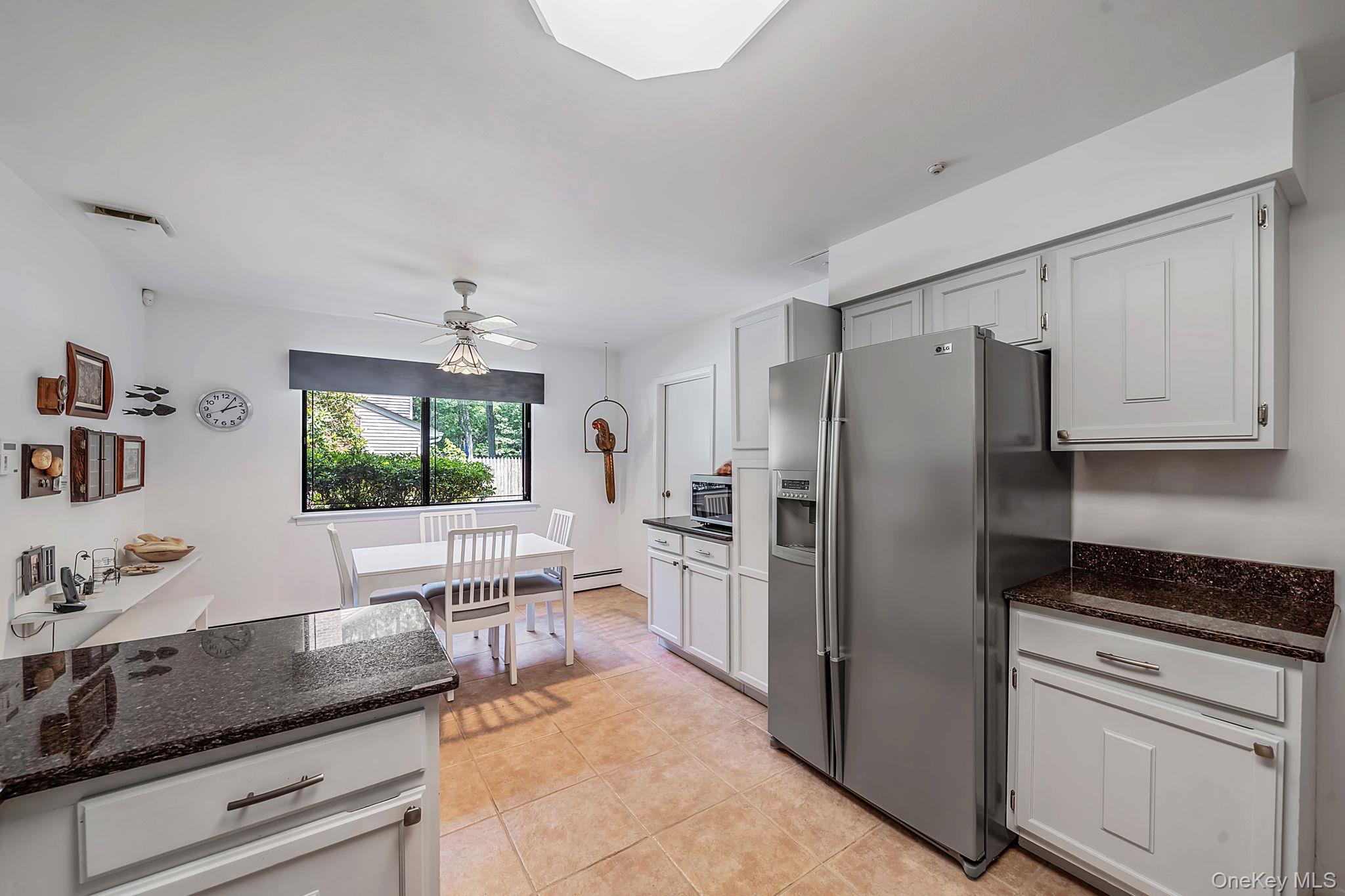 96 Fulton Boulevard Commack, NY 11725 - Photo 20 of 41 a kitchen with granite countertop a refrigerator and a stove top oven