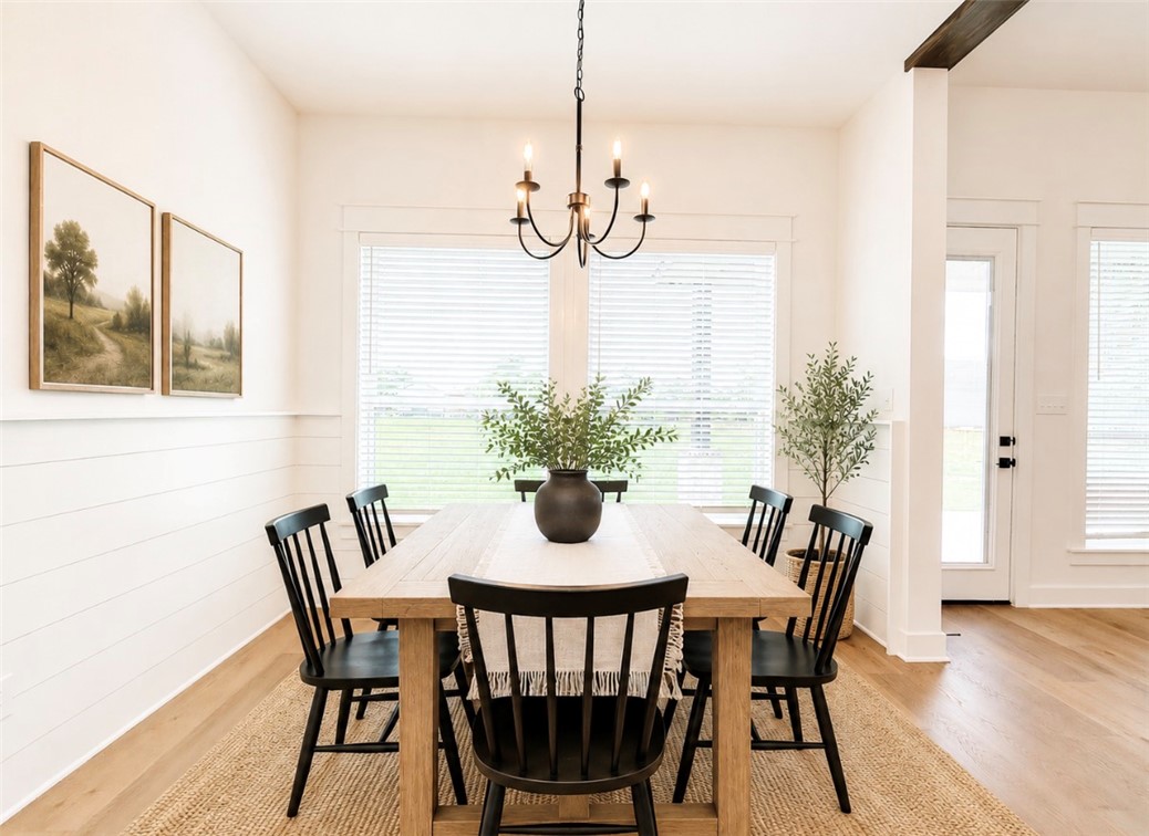 3245 Hunters Crossing Bryan, TX 77808 - Photo 6 of 30 Dining area featuring light wood-finish flooring and a shiplap accent wall