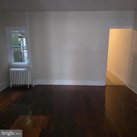a view of an empty room and wooden floor
