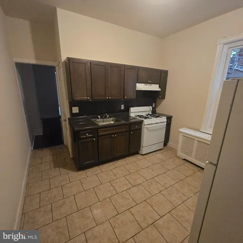 a kitchen with stainless steel appliances a sink and cabinets