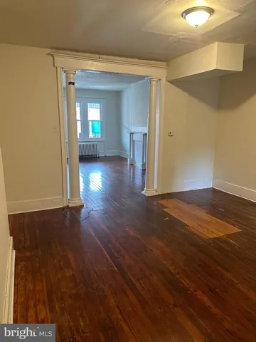 a view of a room with wooden floor and window