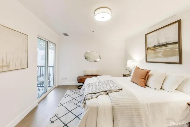 a bedroom with a large bed and a window