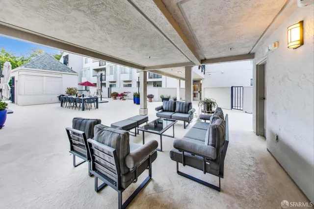 a living room with furniture and a potted plant