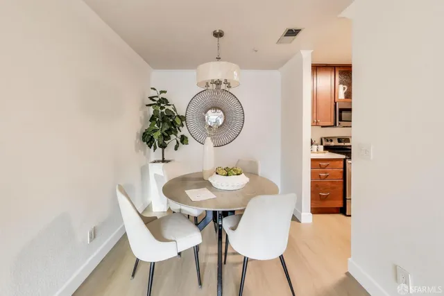 a view of a dining room with furniture and wooden floor