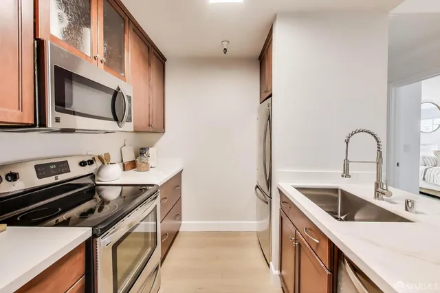 a kitchen with stainless steel appliances granite countertop a sink and a microwave