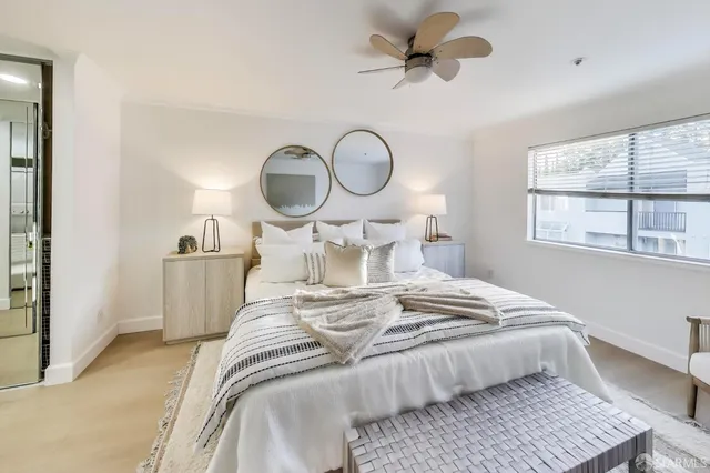 a bedroom with bed and a window