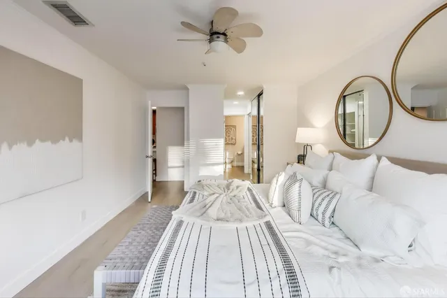 a bed room with a bed mirror and a window