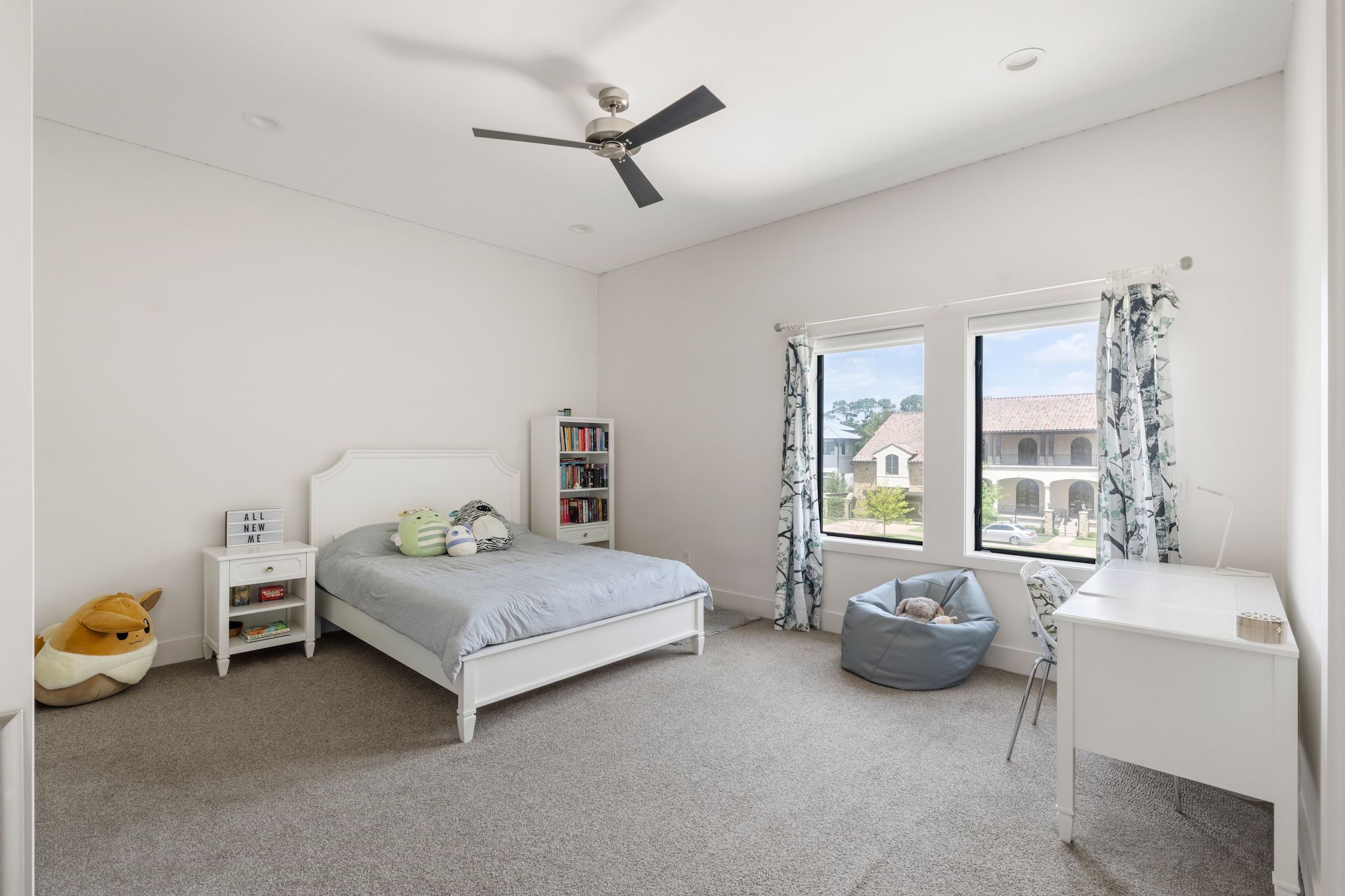 5427 Maple Street Houston, TX 77096 - Photo 34 of 46 This bright bedroom features a pair of windows along one wall overlooking the neighborhood, with a ceiling fan adding both comfort and height to the space.