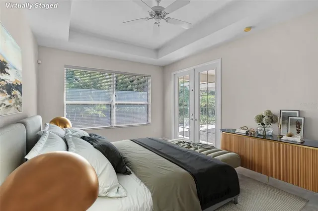 a bedroom with bed and a large window