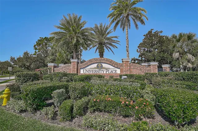 a view of a house with a yard and potted plants