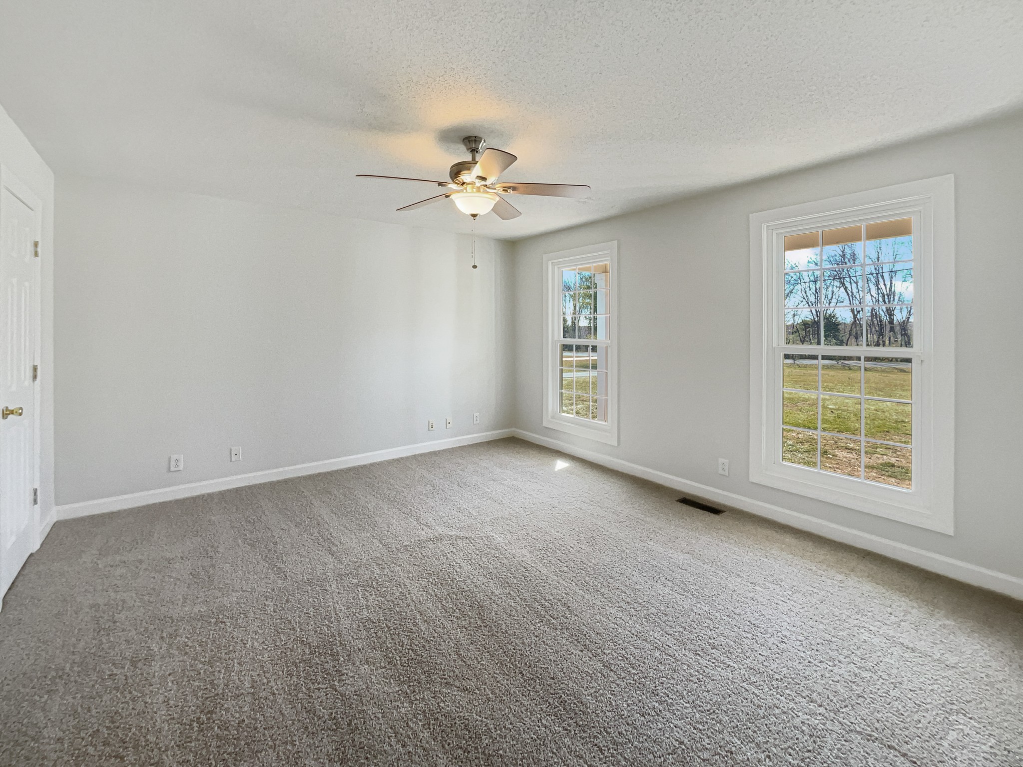 1683 South Walker Road Pleasant View, TN 37146 - Photo 16 of 26 an empty room with chandelier fan and windows