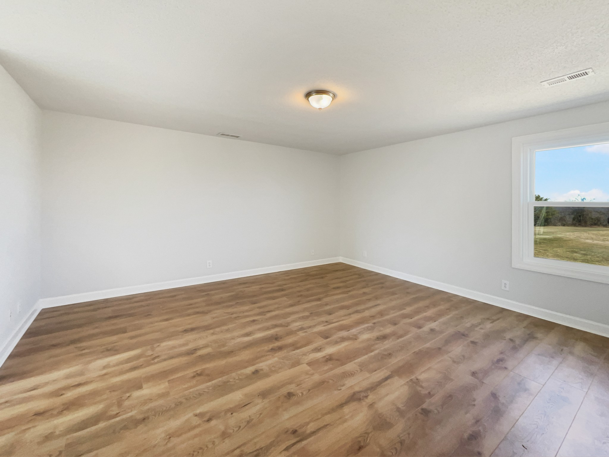 1683 South Walker Road Pleasant View, TN 37146 - Photo 17 of 26 a view of empty room with wooden floor and fan