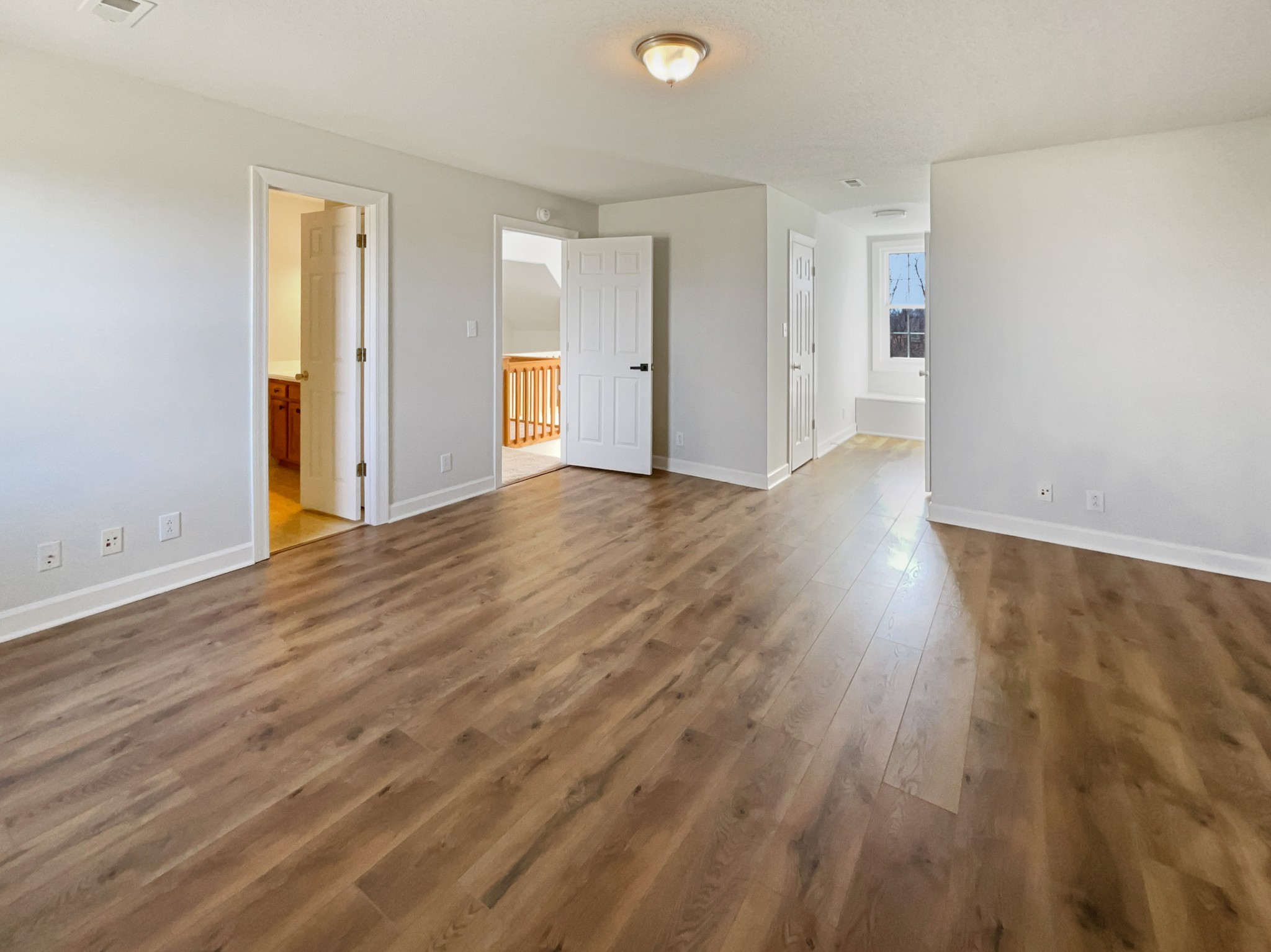 1683 South Walker Road Pleasant View, TN 37146 - Photo 18 of 26 an empty room with wooden floor and windows