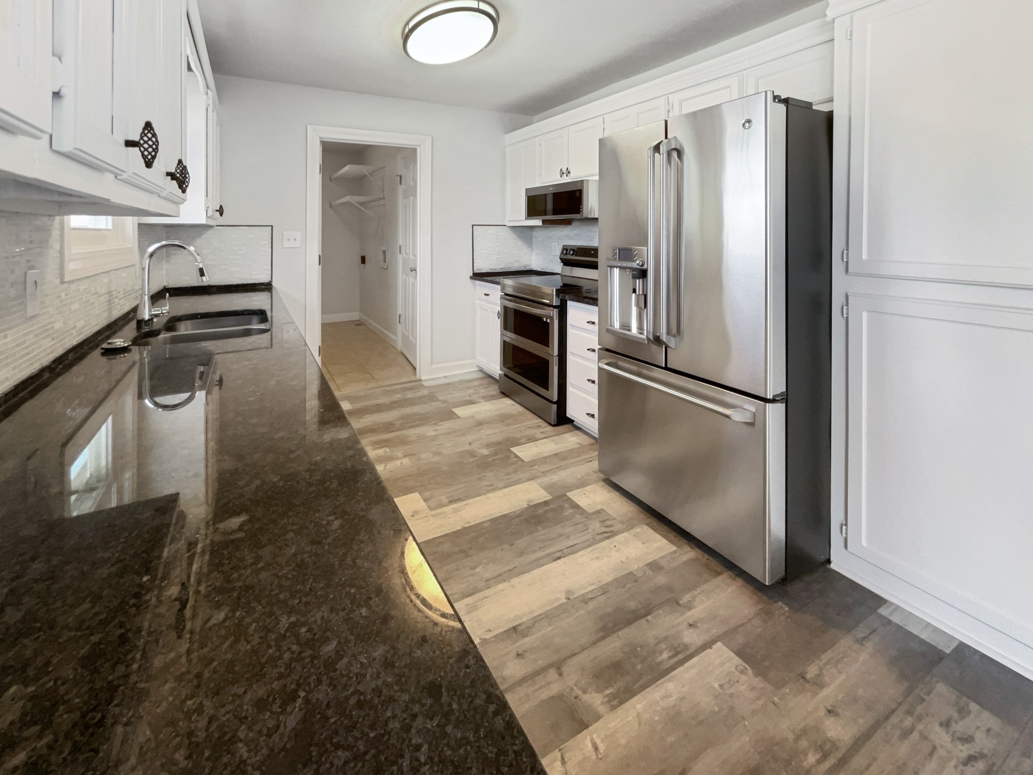 1683 South Walker Road Pleasant View, TN 37146 - Photo 6 of 26 a kitchen with stainless steel appliances granite countertop a refrigerator a stove and a sink