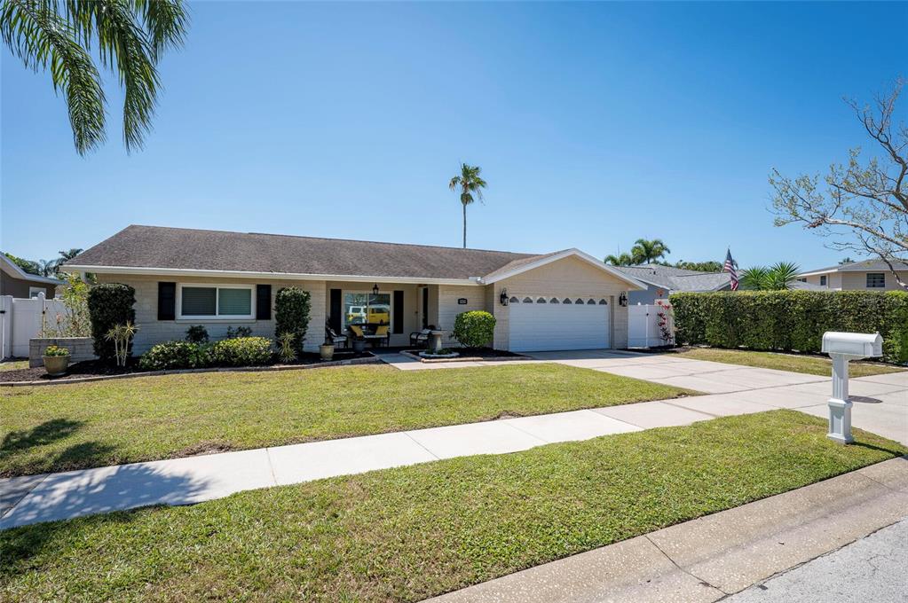 12312 89th Terrace Seminole, FL 33772 - Photo 1 of 1 a front view of a house with a garden and yard
