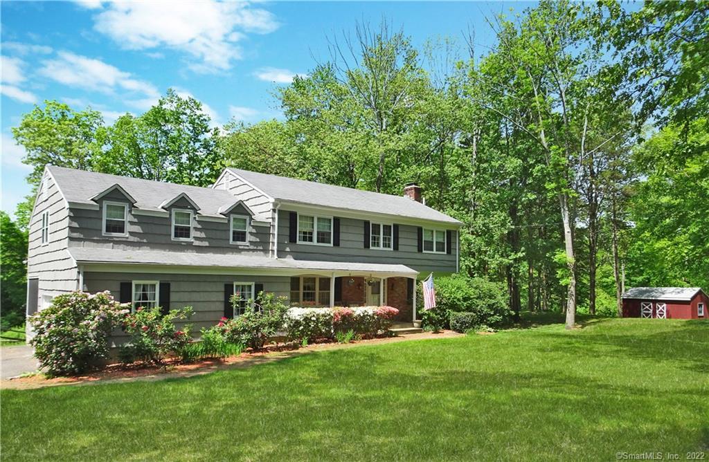 181 Spoonwood Road Wilton, CT 06897 - Photo 1 of 1 a front view of a house with a garden