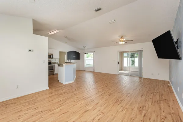 a view of a kitchen with furniture and wooden floor