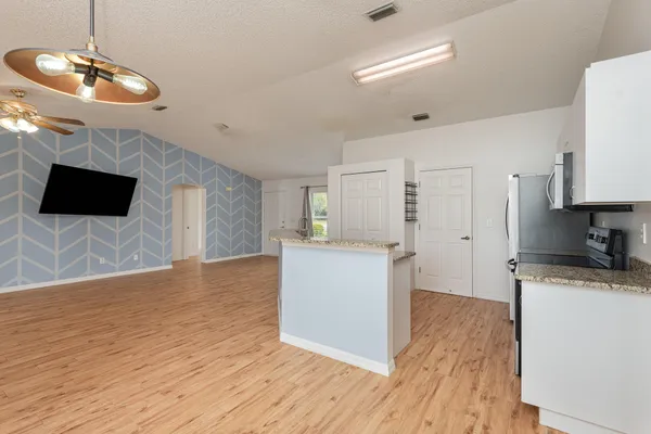 a view of a kitchen with microwave and cabinets