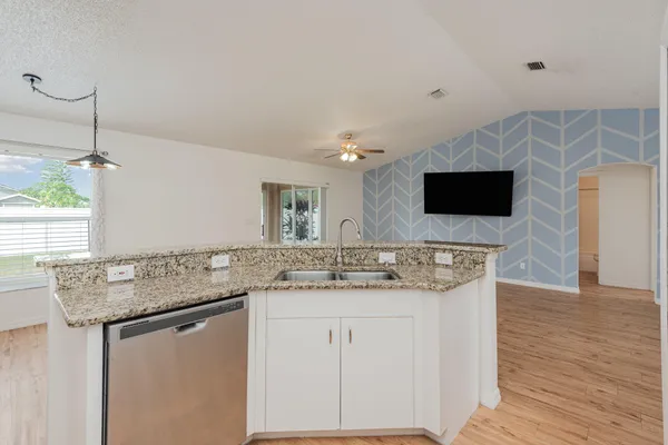 a kitchen with stainless steel appliances granite countertop a sink and a microwave