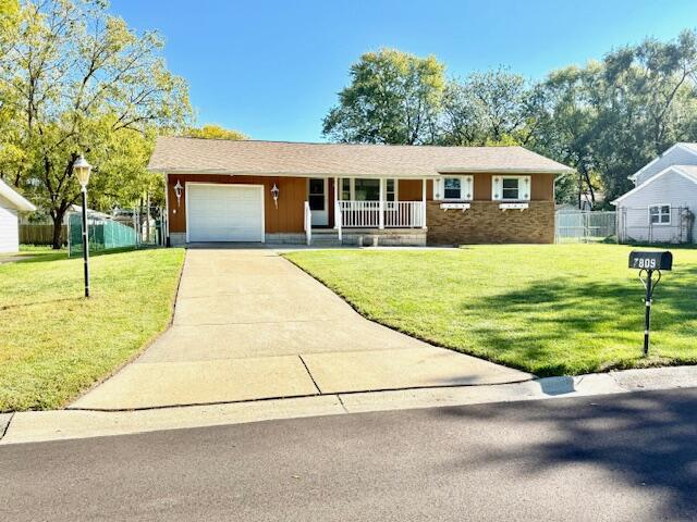 7809 Chase Street Merrillville, IN 46410 - Photo 33 of 33 a front view of a house with a yard and trees