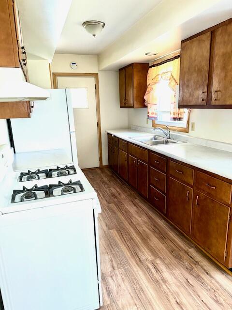 7809 Chase Street Merrillville, IN 46410 - Photo 7 of 33 a kitchen with stainless steel appliances a stove a sink and a refrigerator