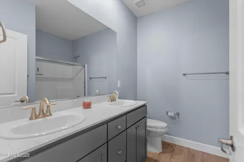 a bathroom with a sink toilet and mirror