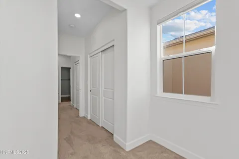 an entryway of a house and an empty room with windows